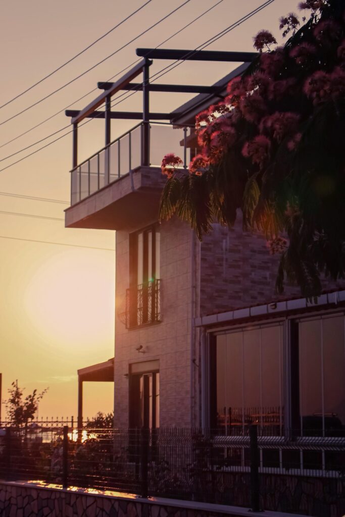 Contemporary house with floral terrace and sunset view, showcasing modern architecture and nature.