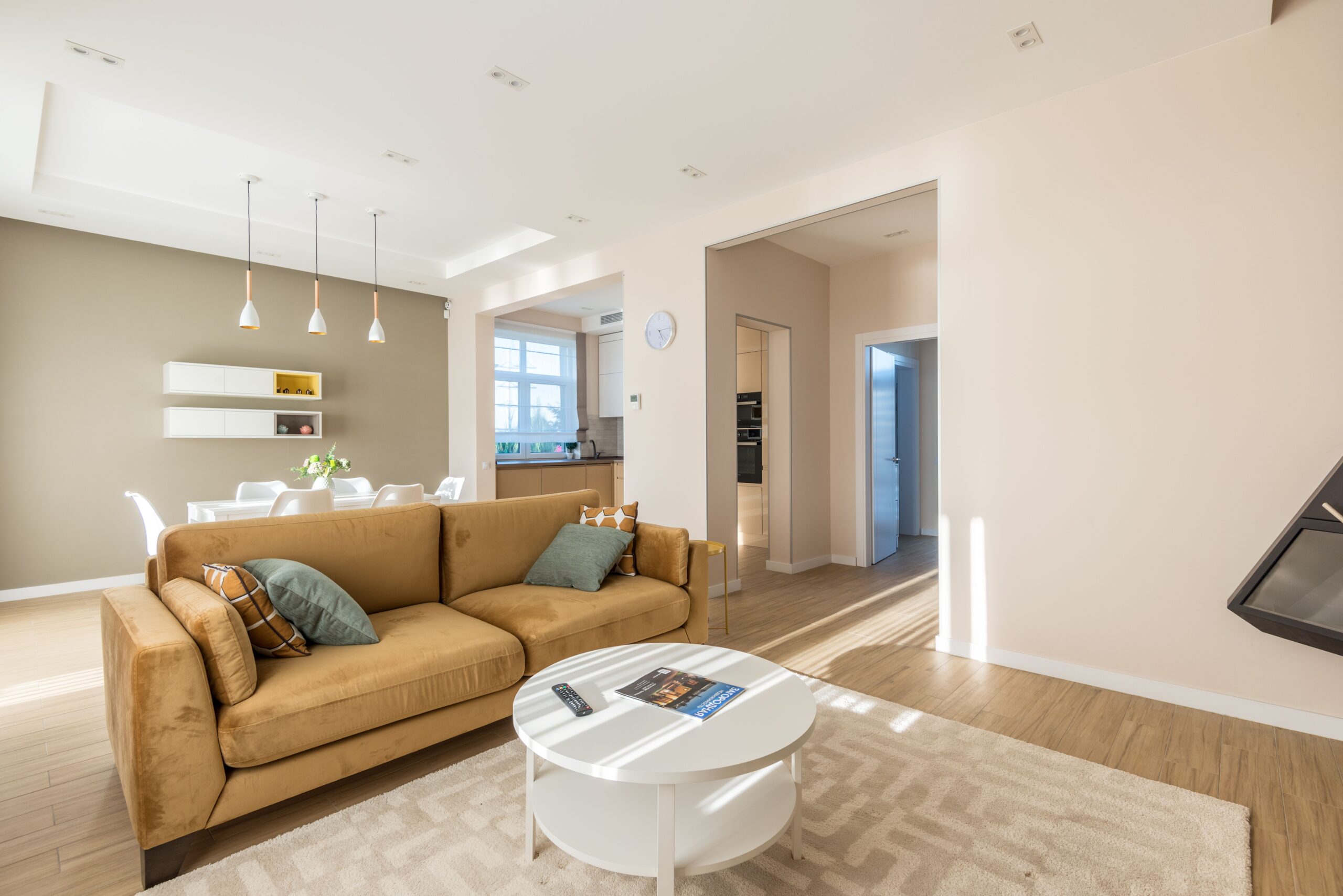 Bright and spacious living room with a modern design featuring a stylish sofa and elegant decor.